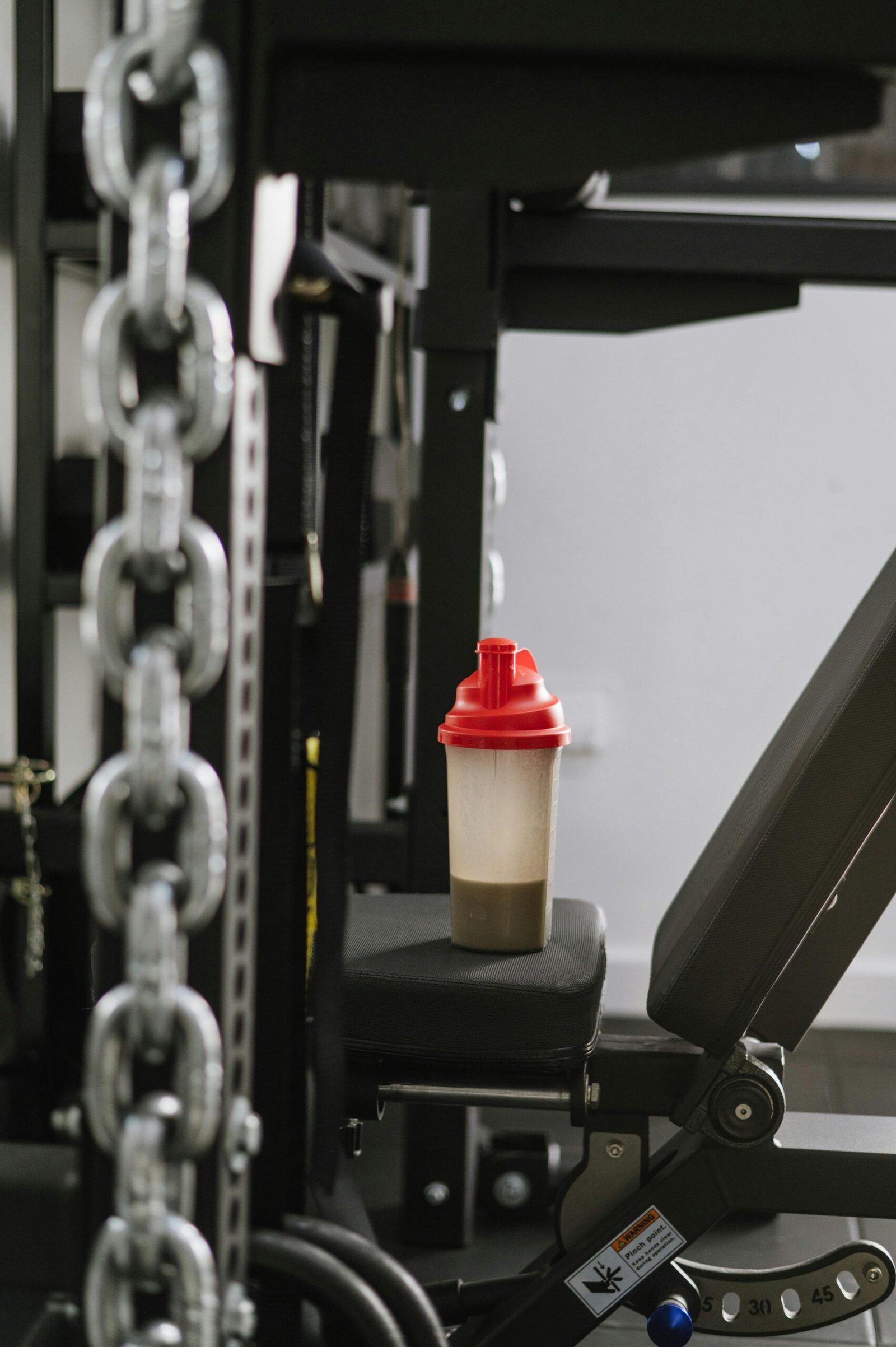 pexels photo 16513595 16513595 A protein shake bottle on gym equipment symbolizing fitness and health.